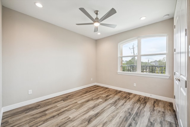 unfurnished room featuring ceiling fan and hardwood / wood-style floors