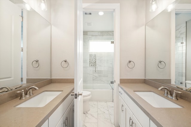 full bathroom with tile patterned flooring, shower / bath combination with glass door, toilet, and vanity