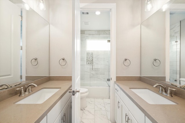 bathroom with marble finish floor, two vanities, and a sink