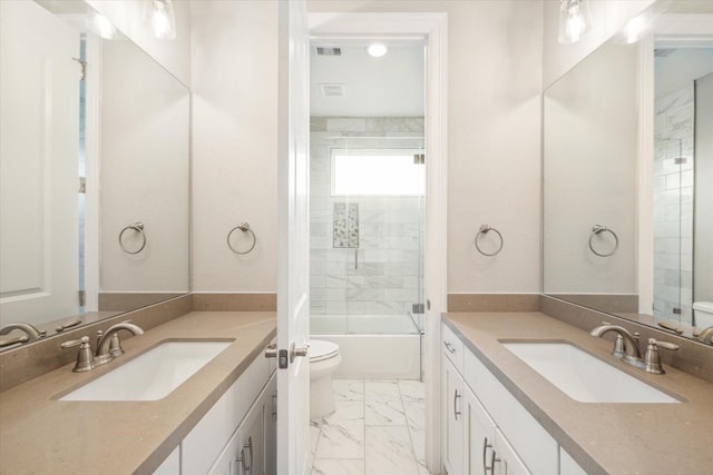 502 Amalfi Dr, Kemah, TX 77565 - full bathroom featuring marble look tile flooring, two vanities, toilet, and shower / bathtub combination