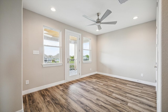 unfurnished room with baseboards, wood finished floors, and recessed lighting