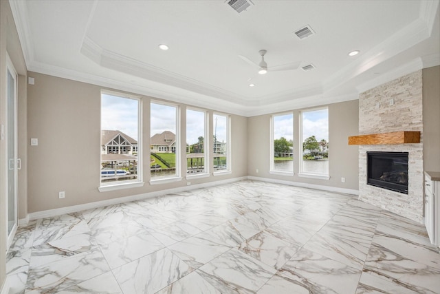 unfurnished living room with a raised ceiling, visible vents, crown molding, and a fireplace