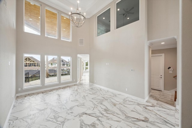 502 Amalfi Dr, Kemah, TX 77565 - unfurnished living room with light marble finish floors, ornamental molding, baseboards, a chandelier, and a high ceiling