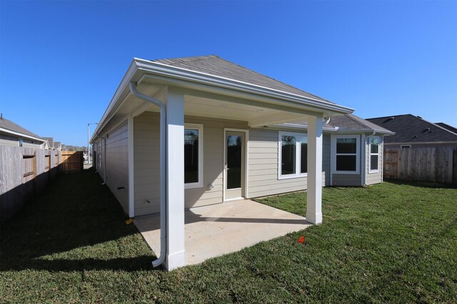 back of house featuring a patio area and a yard