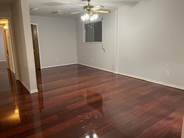 spare room featuring ceiling fan and dark hardwood / wood-style floors