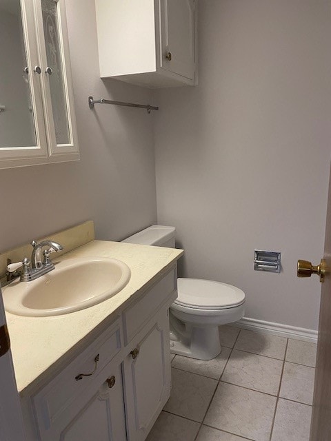 bathroom featuring tile patterned flooring, vanity, and toilet