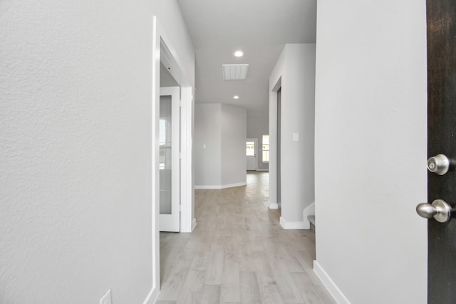 hall with light hardwood / wood-style flooring