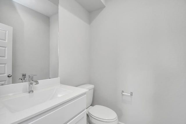 bathroom with toilet and vanity