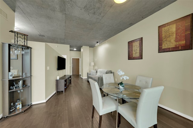 dining area with dark hardwood / wood-style flooring