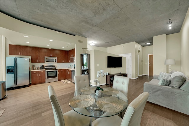 dining space with light hardwood / wood-style floors