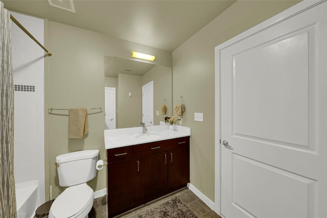 full bathroom with tile patterned floors, tiled shower / bath, toilet, and vanity