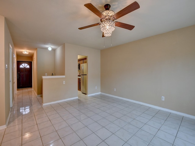 spare room featuring light tile patterned floors and ceiling fan