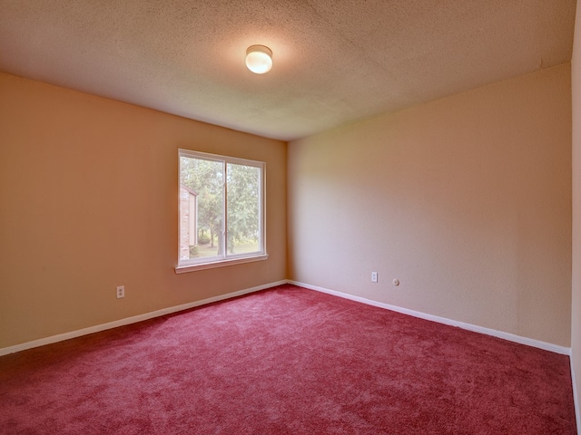 carpeted spare room with a textured ceiling