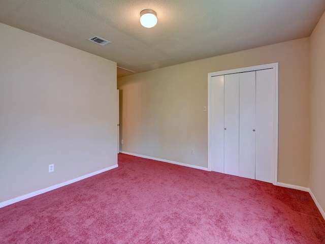 unfurnished bedroom featuring a closet and carpet