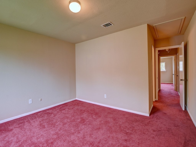 unfurnished room featuring carpet and a textured ceiling