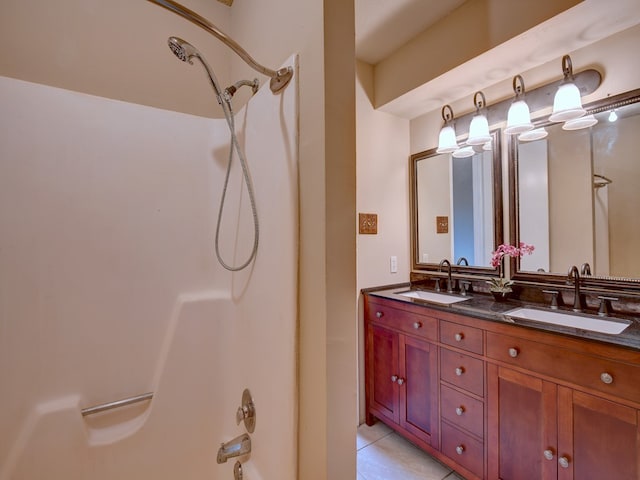 bathroom featuring tile patterned flooring, shower / bathtub combination, and vanity