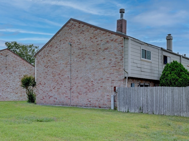 view of home's exterior with a lawn