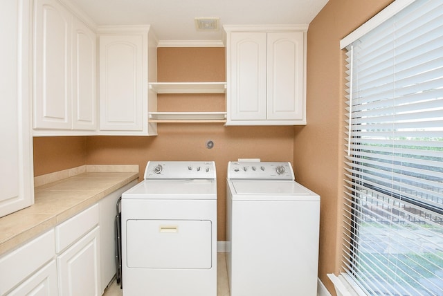 laundry area featuring cabinets and washer and dryer