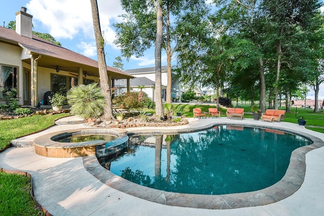 view of swimming pool with an in ground hot tub, ceiling fan, and a patio area