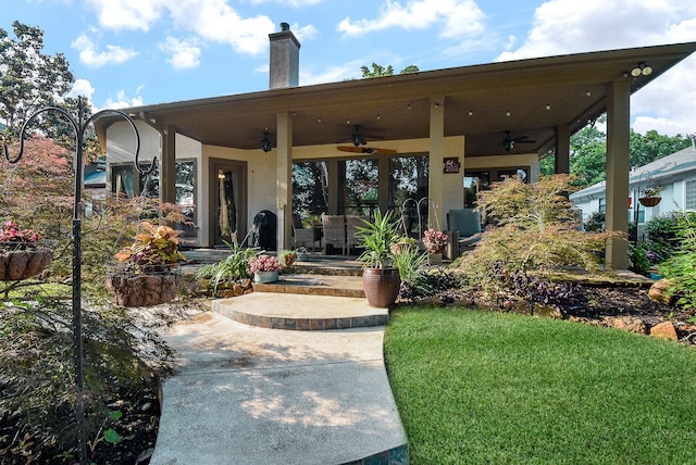 view of front facade featuring ceiling fan and a front yard