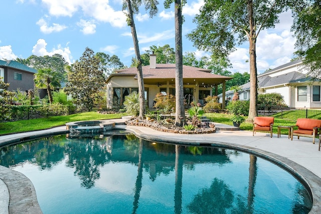 view of swimming pool featuring a patio and an in ground hot tub