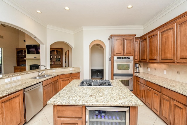 kitchen featuring light stone counters, wine cooler, and appliances with stainless steel finishes