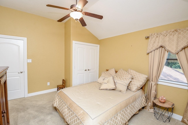 bedroom featuring carpet flooring, vaulted ceiling, ceiling fan, and a closet