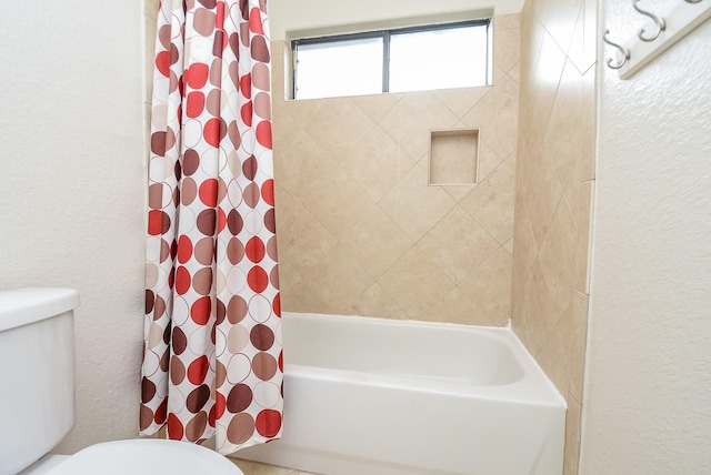 bathroom featuring shower / bath combo and toilet