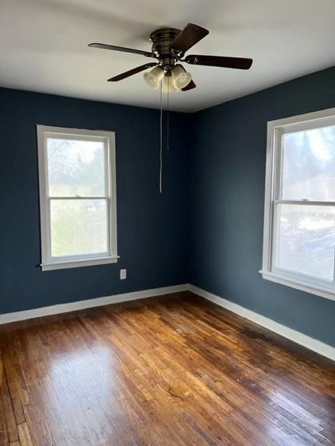 unfurnished room with a healthy amount of sunlight and dark hardwood / wood-style floors