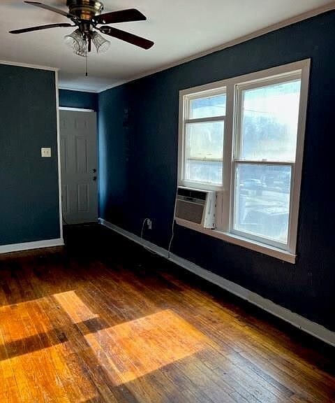 2410 Milby St, Houston, TX 77004 - interior space featuring a ceiling fan, cooling unit, hardwood / wood-style floors, and baseboards