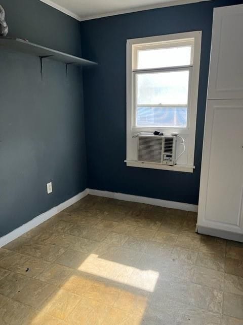 unfurnished room with light tile patterned floors, ornamental molding, and cooling unit