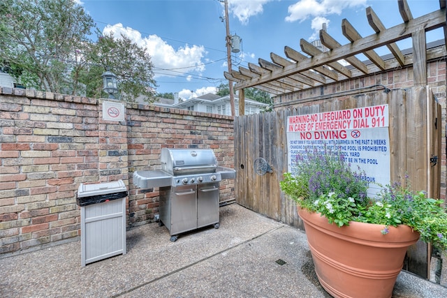 view of patio with a pergola and area for grilling