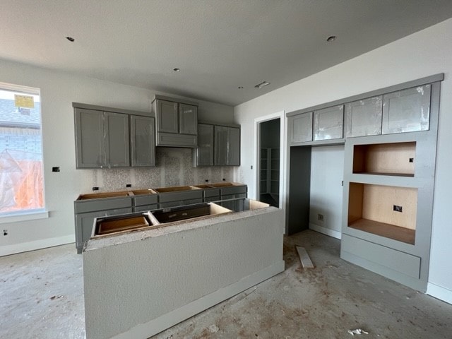 kitchen with gray cabinets and decorative backsplash