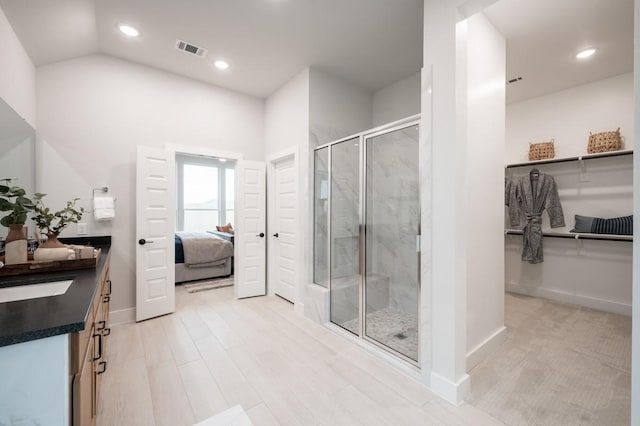 bathroom with a shower with door, vanity, and hardwood / wood-style floors