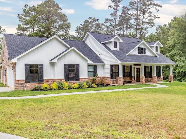 view of front facade with a garage, a porch, and a front lawn