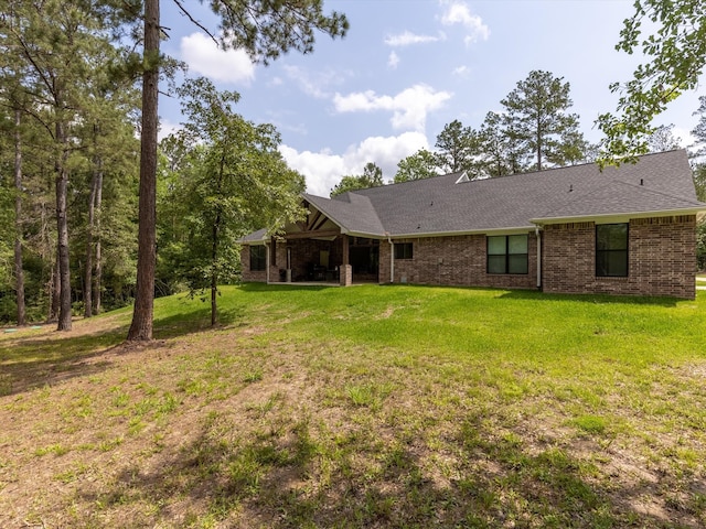 rear view of property with a lawn