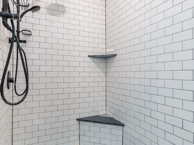 bathroom with a tile shower