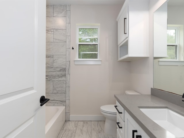 full bathroom with tile patterned flooring, tiled shower / bath, vanity, and toilet