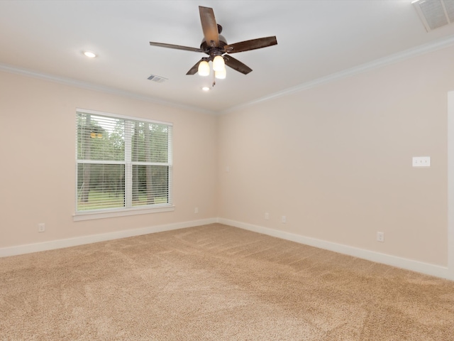 unfurnished room featuring ceiling fan, crown molding, and light colored carpet