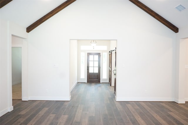 entrance foyer with high vaulted ceiling, dark hardwood / wood-style flooring, beamed ceiling, and a barn door