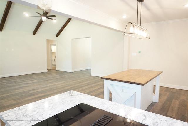 interior space featuring vaulted ceiling with beams, butcher block counters, dark hardwood / wood-style floors, ceiling fan, and pendant lighting