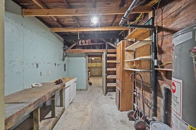 basement featuring a workshop area and water heater