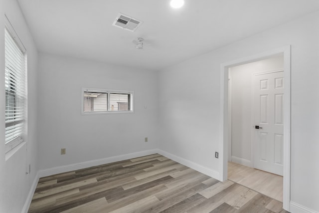 spare room featuring wood-type flooring