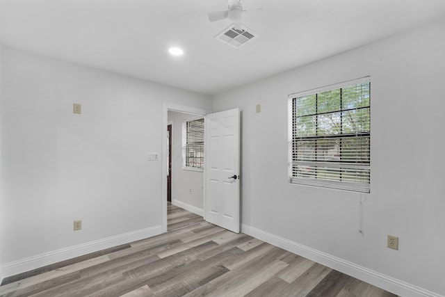 spare room featuring ceiling fan and light hardwood / wood-style floors