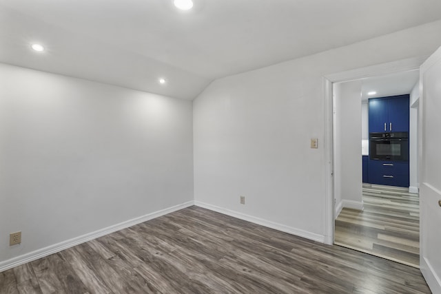 spare room featuring dark wood-type flooring