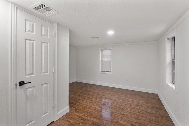 unfurnished room featuring a textured ceiling and dark hardwood / wood-style floors