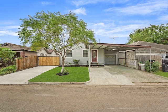 view of front of property featuring a carport, a garage, and a front lawn