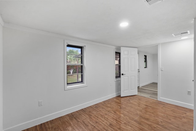 unfurnished room with hardwood / wood-style floors