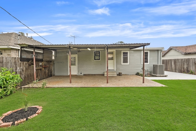 rear view of house with a yard, a patio area, and central air condition unit