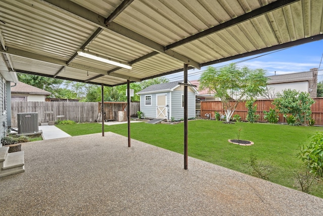 view of patio / terrace with cooling unit and a storage shed